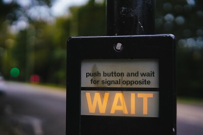 How do you politely tell someone to wait?